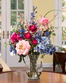 Gorgeous Painter's Palette Silk Flower Arrangement in Mixed Soft Tones designed in a 7" jardin vase of crystal clear acrylic water
